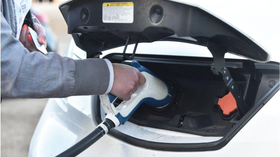 A lady is seen using a electric vehicle charging pod point on November 15, 2020 in Stoke-On-Trent, England