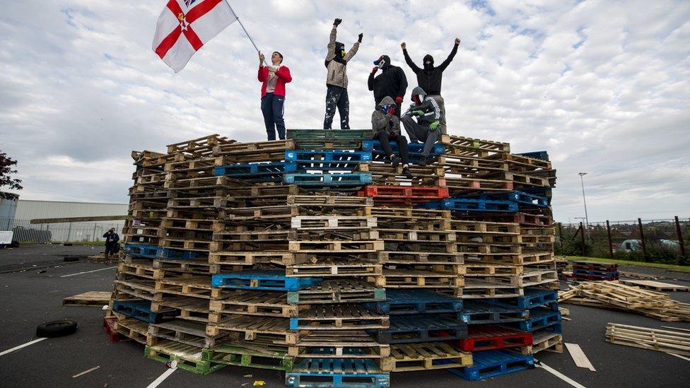 Loyalists standing on the bonfire at Avoniel Leisure Centre