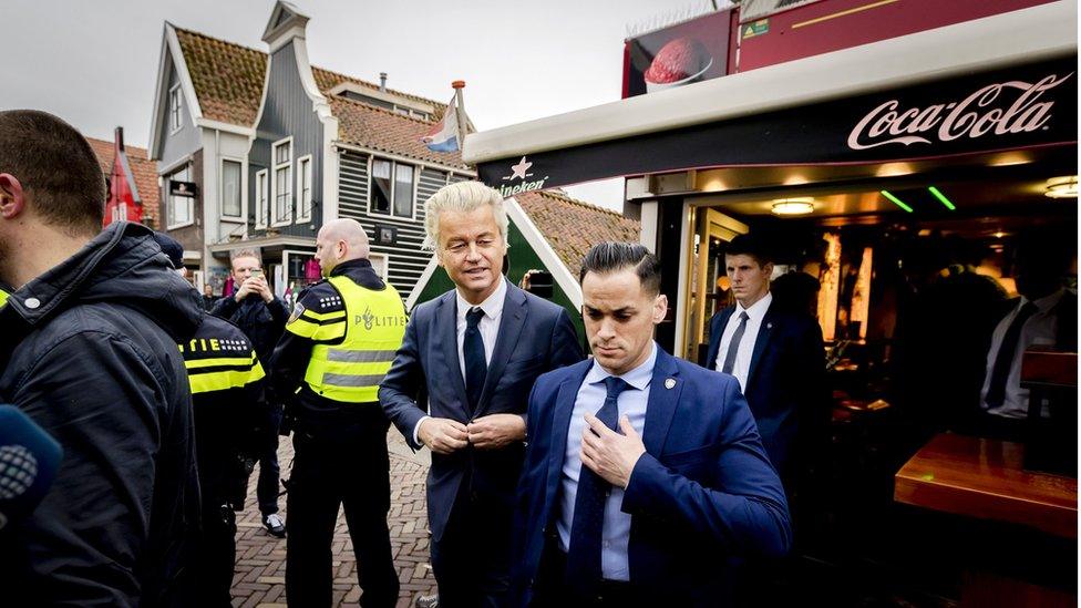 Dutch member of Parliament and leader of the far-right Party for Freedom (PVV) Geert Wilders (C) visits Volendam on 3 March