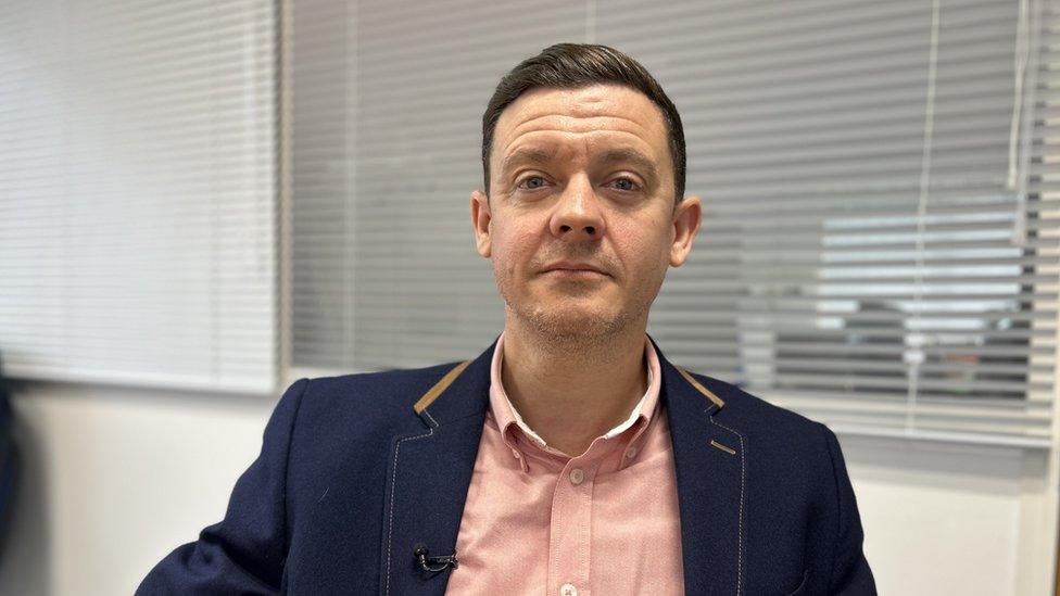 CEO Matt Fellows sitting looking at the camera in a jacket and light-coloured shirt