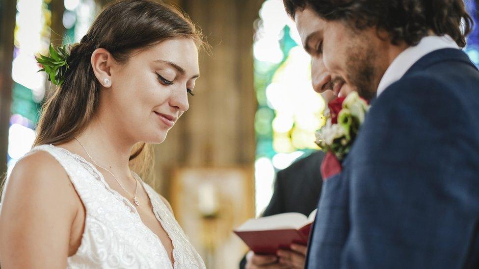 Bride and groom at the altar - stock image