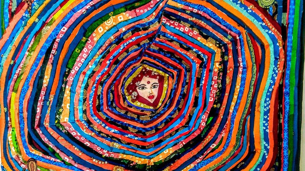 A fabric collage made from tiny scraps of recycled textiles and fabric waste