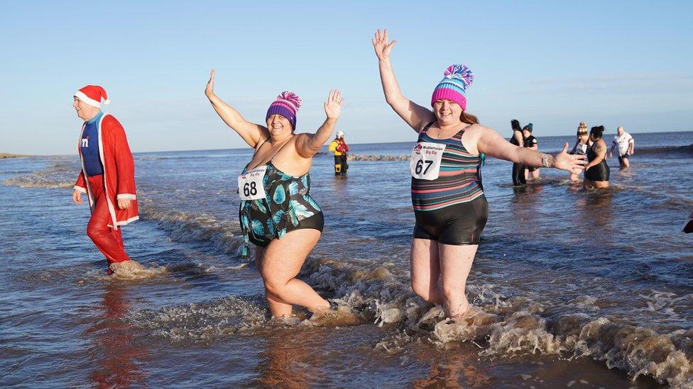 People take part in the New Year's day Mablethorpe Big Dip in Lincolnshire