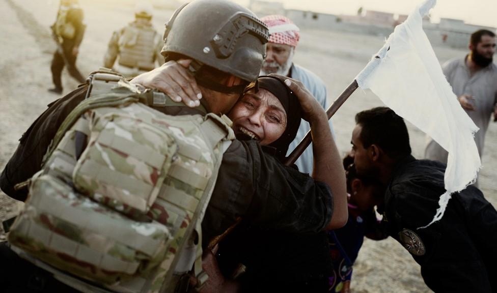 A female civilian hugs a solider after the Golden Division captured Bazwaya, the last village on the outskirts of Mosul (24 October 2016)