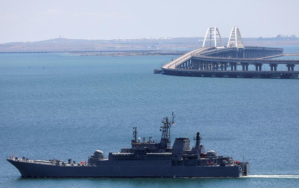 A Russian Navy amphibious landing ship that was deployed to transport cars across the Kerch Strait, moves near the Crimean Bridge