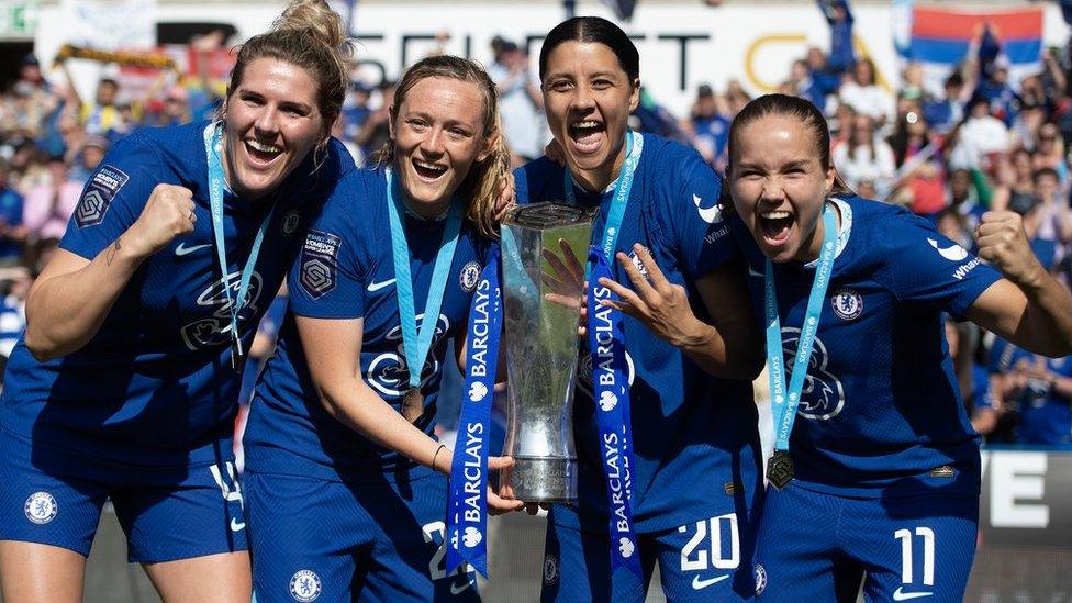 Chelsea players celebrate with the WSL trophy