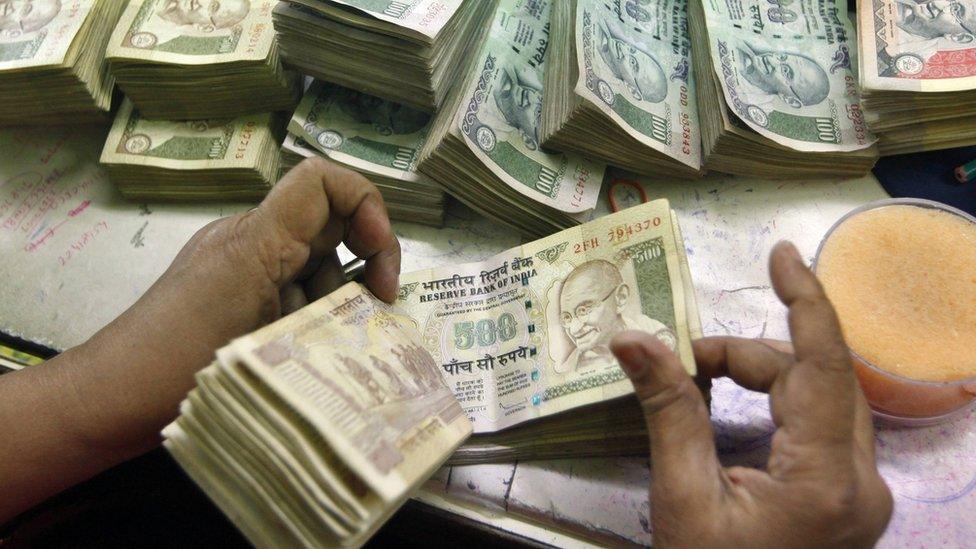 Indian currency at a cash counter inside a bank in Calcutta in June 2012