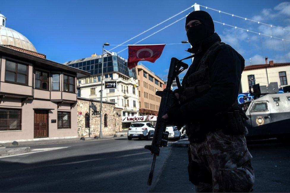 A Turkish special force police officer stands guard at ortakoy district near the Reina night club, on January 2, 2017 in Istanbul, one day after New Year gun attack.