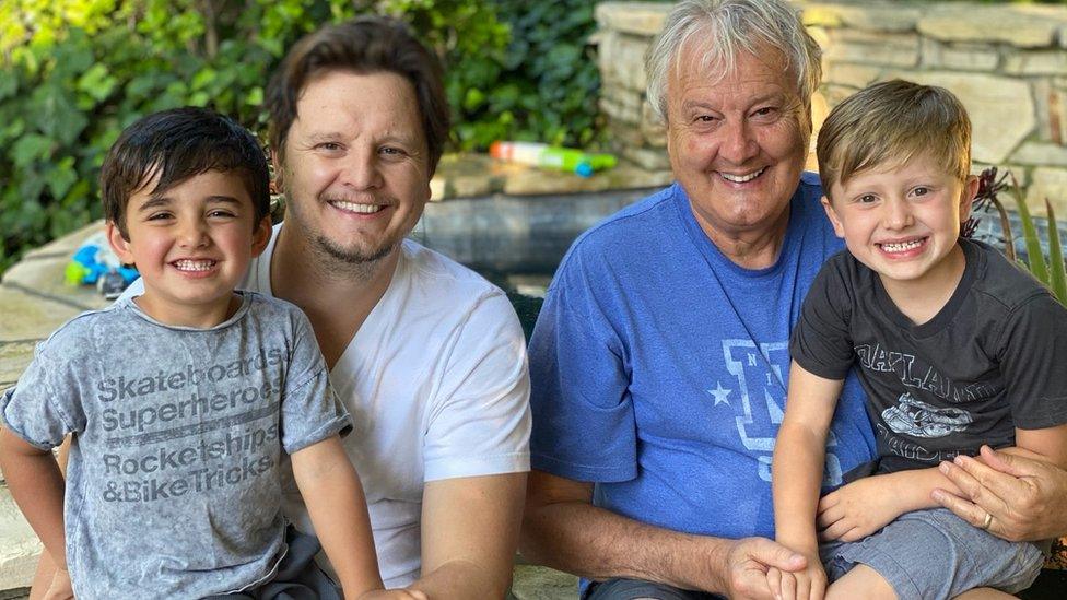 Mike Young (right) with son Pete, with Mike's grandsons Bodhi and Owen