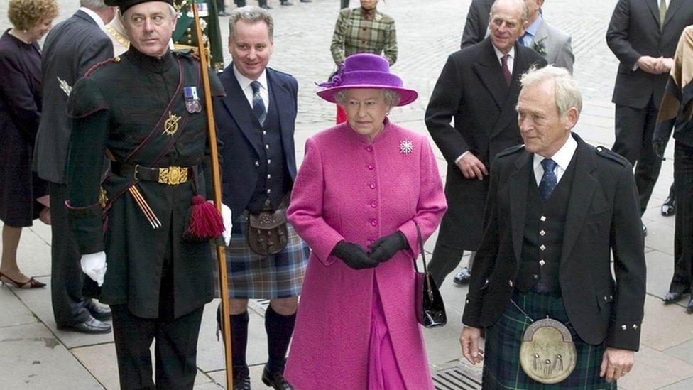 Queen Elizabeth arrives at Parliament Square in Edinburgh, flanked by First Minister Jack McConnell (fourth from left) and Presiding Officer George Reid (right) in October 2004