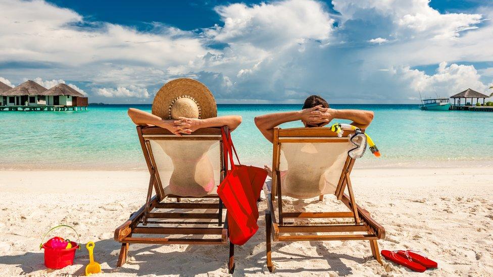 A couple on a beach in the Maldives