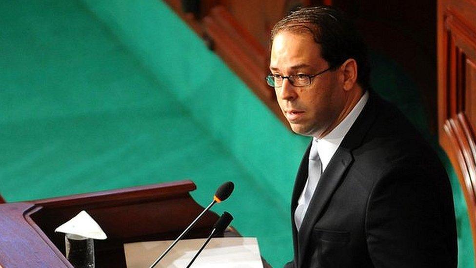 Newly named Tunisian Prime Minister Youssef Chahed, centre, delivers his speech at f the Parliament in Tunis, Friday 26 August, 2016 ahead of a confidence vote.