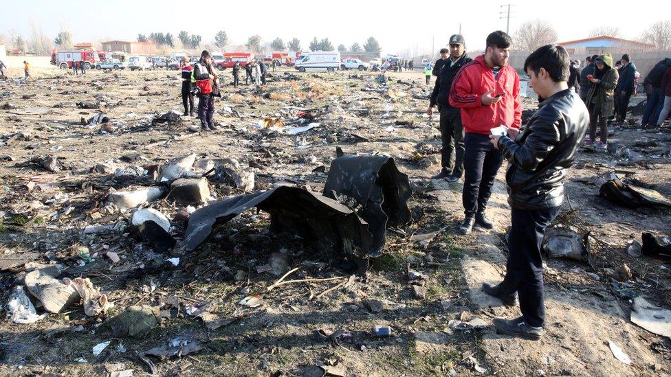 Iranian emergency services personnel inspect the wreckage of Ukraine International Airlines flight PS752 near Tehran (8 January 2020)