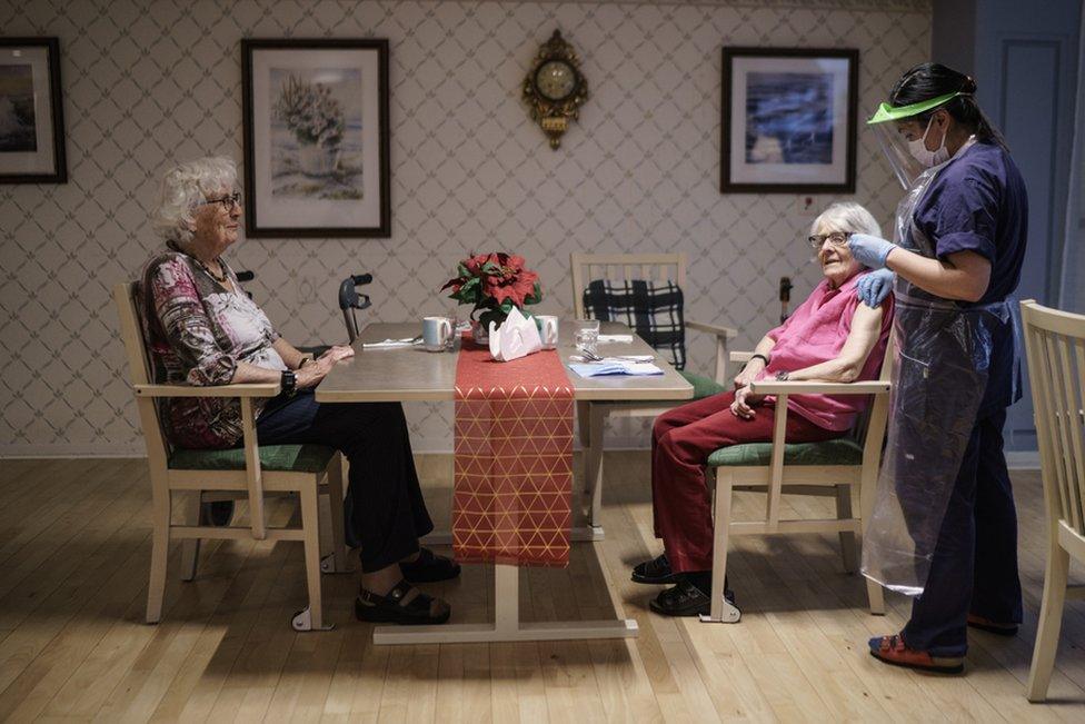 Two women in one of Attendo's nursing home in Gothenburg receive their first of the doses of the Pfizer-BioNtech COVID-19 vaccine on January 7, 2021 in Gothenburg, Sweden.