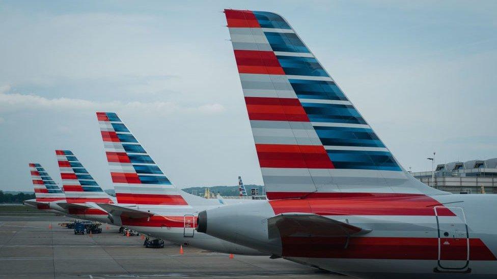 Tails of American Airline planes are seen as the planes sit parked at gates at Reagan National Airport on Thursday, April 27, 2023