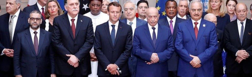 French President Emmanuel Macron, Libyan Prime Minister Fayez al-Sarraj, Khalifa Haftar, the military commander who dominates eastern Libya, and the participants of the International Conference on Libya listen to a verbal agreement between the various parties regarding the organization of a democratic election this year at the Elysee Palace in Paris