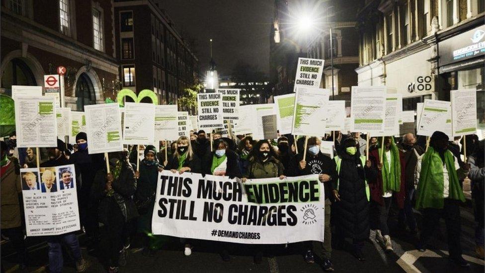 Survivors and bereaved families and friends protesting against the criminal investigation