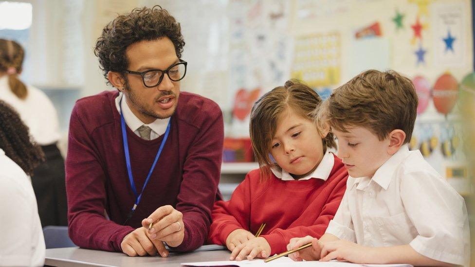 Male teacher with pupils