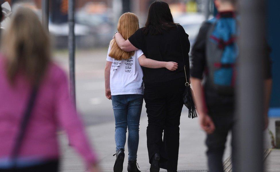 Girl and woman walking away from camera