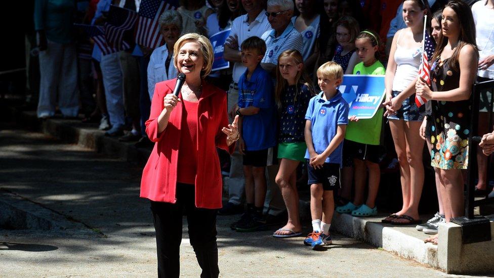 Hillary Clinton speaking in front of a group of children