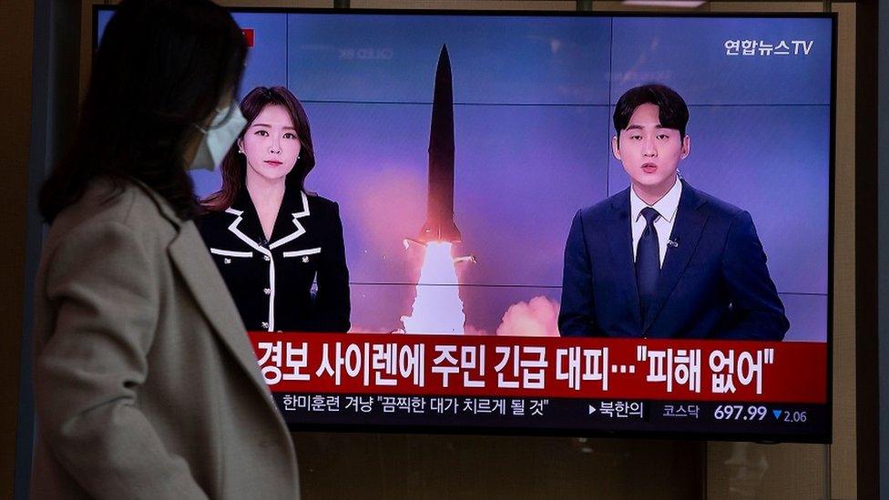 People watch a TV broadcasting a news report on North Korea firing ballistic missiles into the sea, in Seoul, South Korea, November 2, 2022.