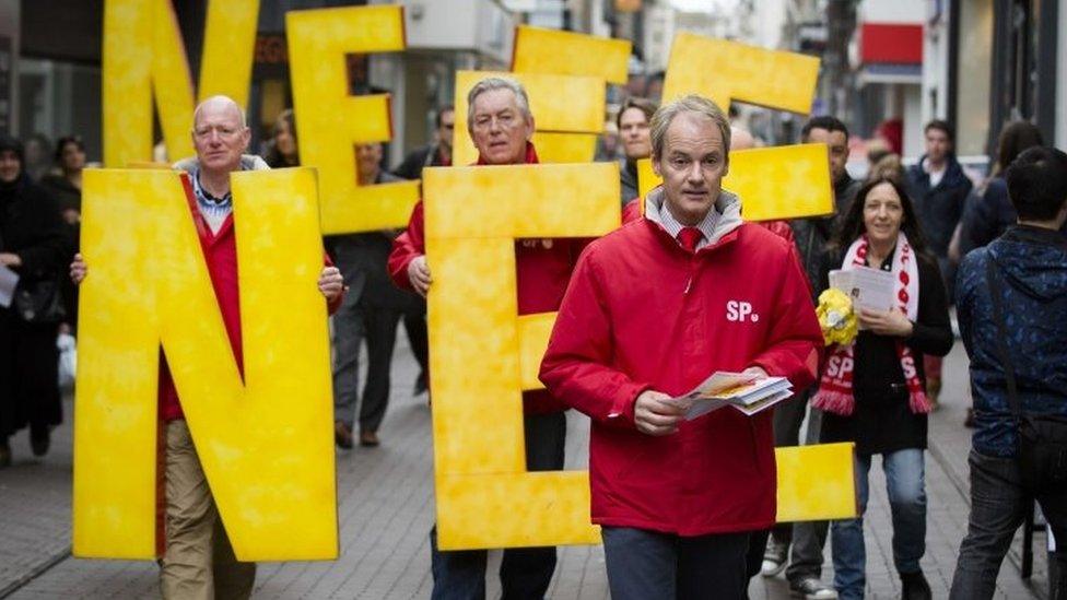 Dutch member of the Socialist Party (SP) Harry van Bommel hands out flyers against a referendum on the association treaty with Ukraine, in the Hague (05 April 2016)