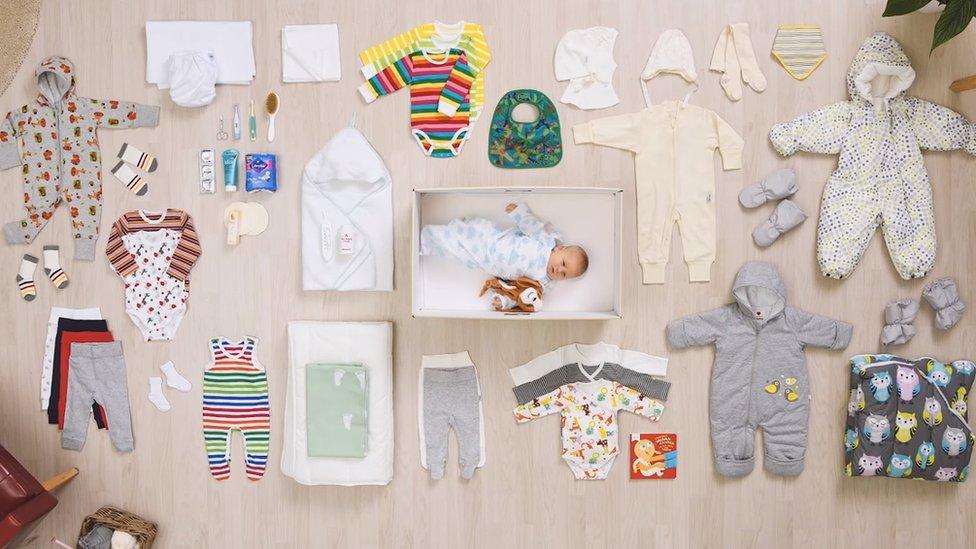 The contents of a Finnish maternity box, plus baby