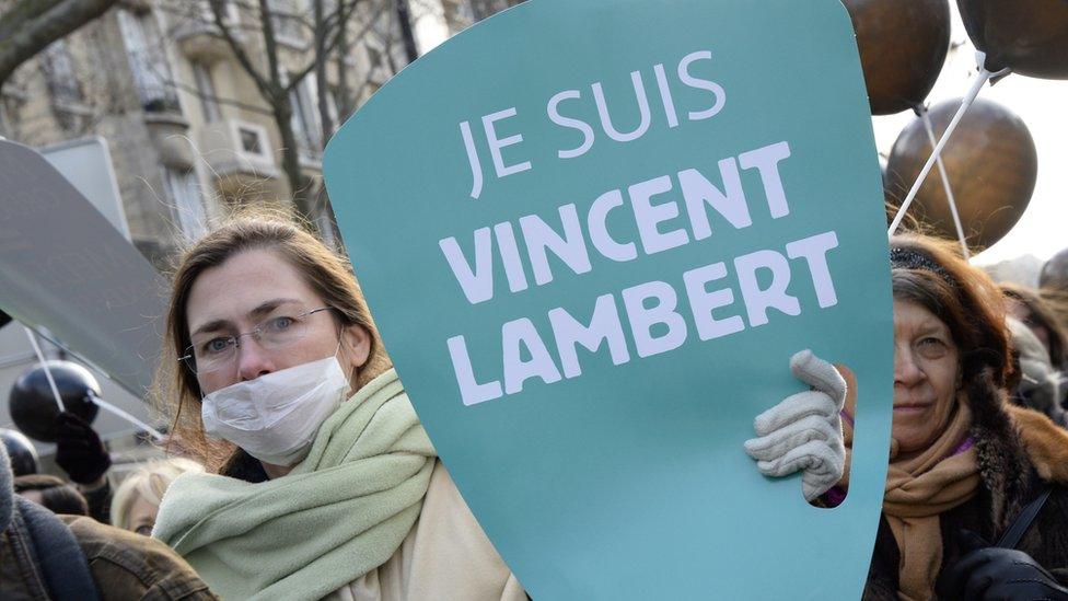 French woman holds a "Je Suis (I am) Vincent Lambert" sign