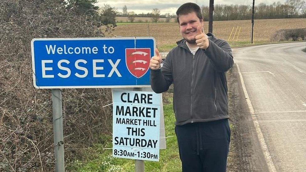 Kireon Wicks at one of the Welcome to Essex signs