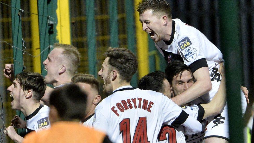 Crusaders players celebrate in front of their fans after Paul Heatley scores in a 3-0 win over the Reds which secured back-to-back title triumphs