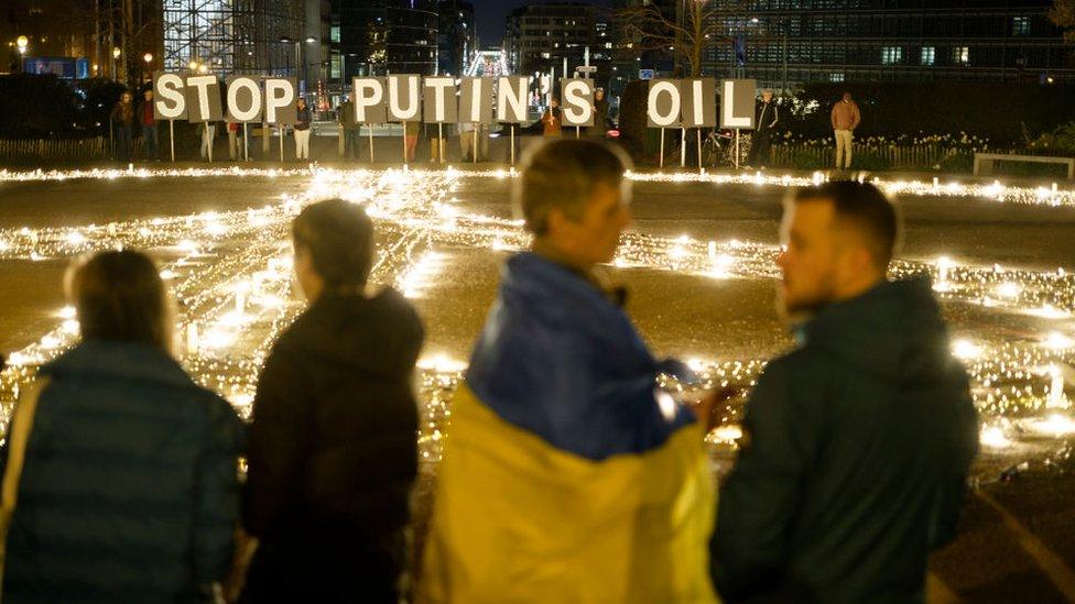 Activists and young Ukrainians demonstrate with a giant peace sign and 'Stop Putin's oil ' in front of the Jusutus Lispsius; the EU Council building and the Berlaymont