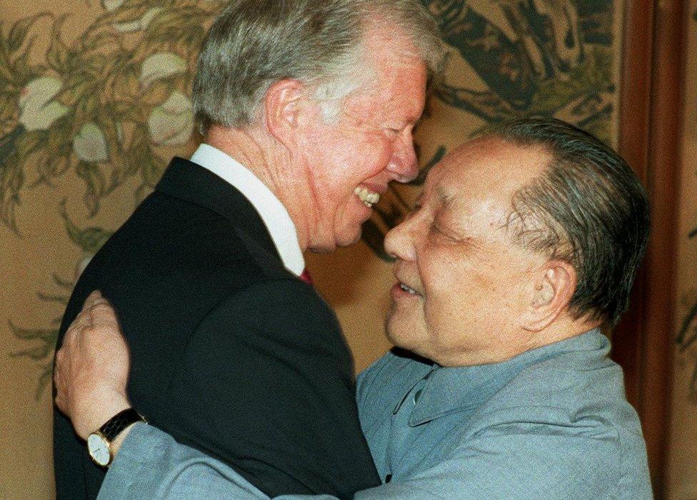 File photo shows former US President Jimmy Carter and China's paramount leader Deng Xiaoping hugging each other 29 June 1987 in Beijing, after signing an agreement between China and Global 2000