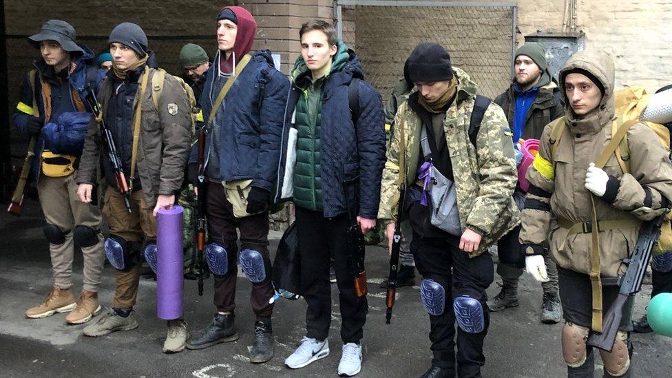 Maksym (far left) and Dmytro (centre, with green jacket and white trainers)