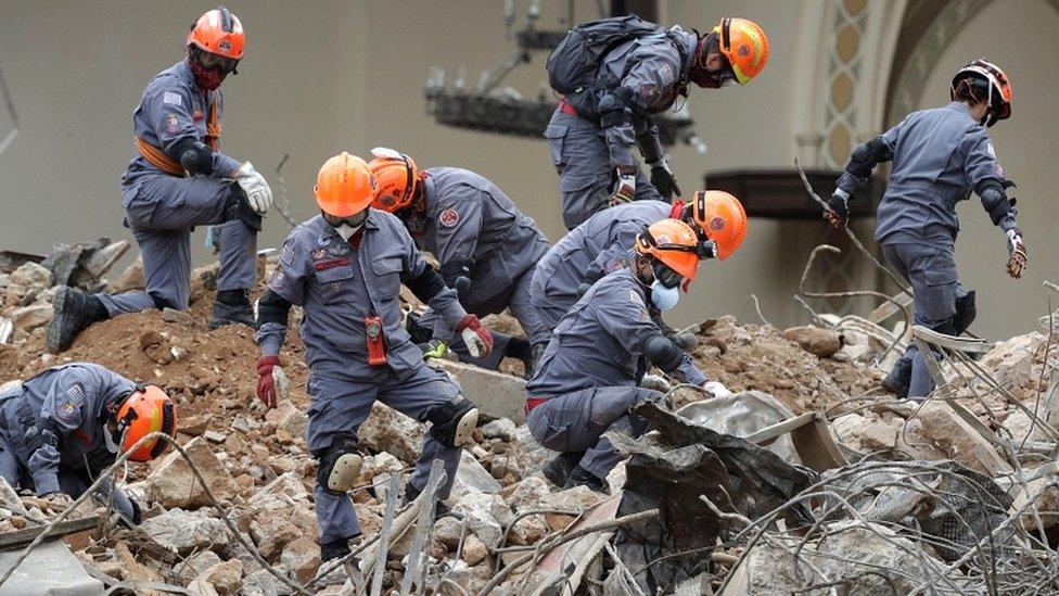 Rescue teams work in the rubble of the building that collapsed as the result of a huge blaze in the centre of Sao Paulo on 8 May 2018