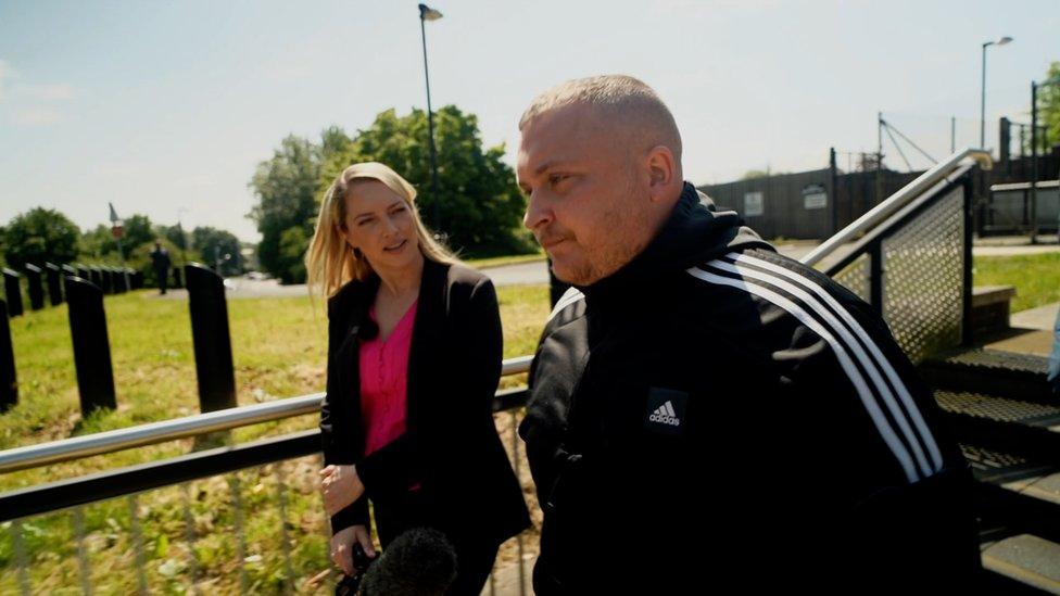 BBC News Ireland correspondent Emma Vardy asks Adrian Douglas questions as he leaves court