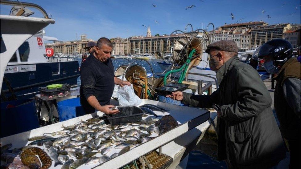 People buy fish in Marseille, 3 May