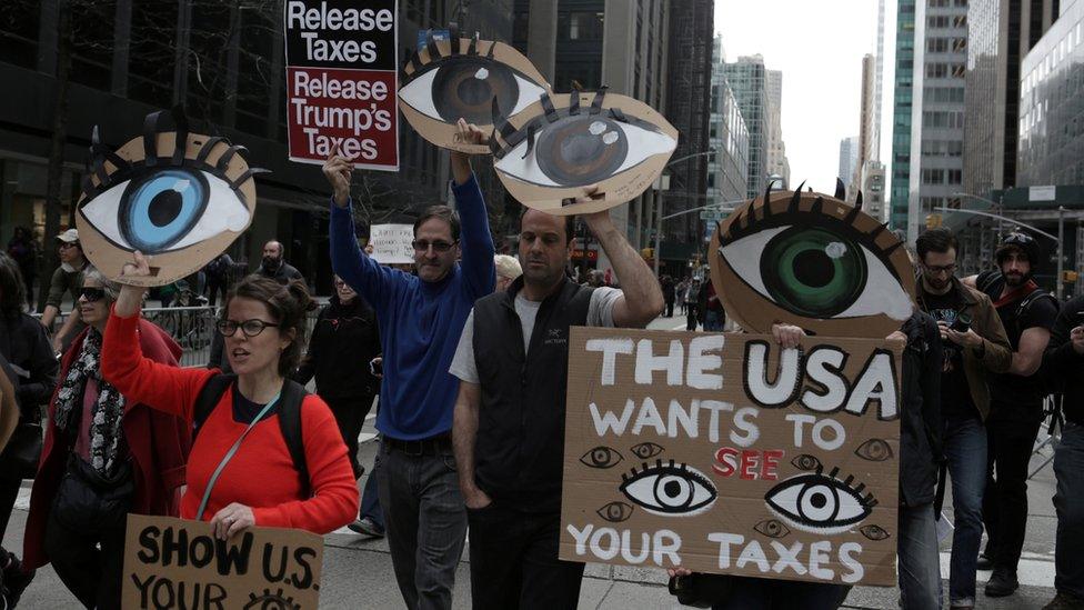 NY 2017 protest with signs about Trump taxes