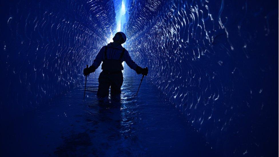 Silhouetted-figure-in-ice-tunnel.