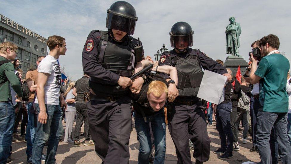 Russian Police forces seen arresting a protester during a demonstration in Moscow's Pushkin Square