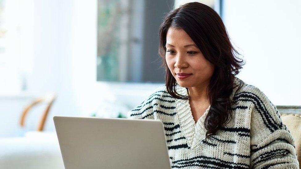 A woman working at her laptop