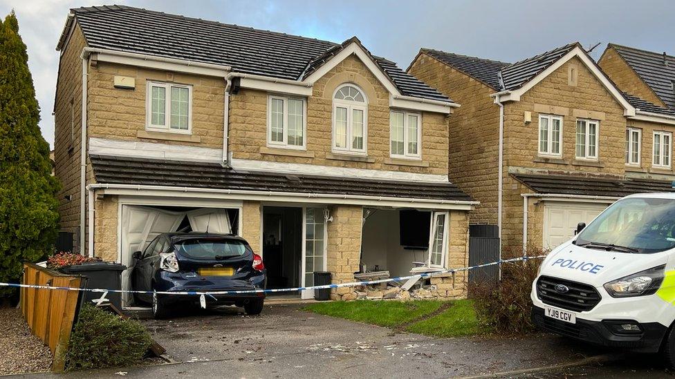 The damaged house and a car