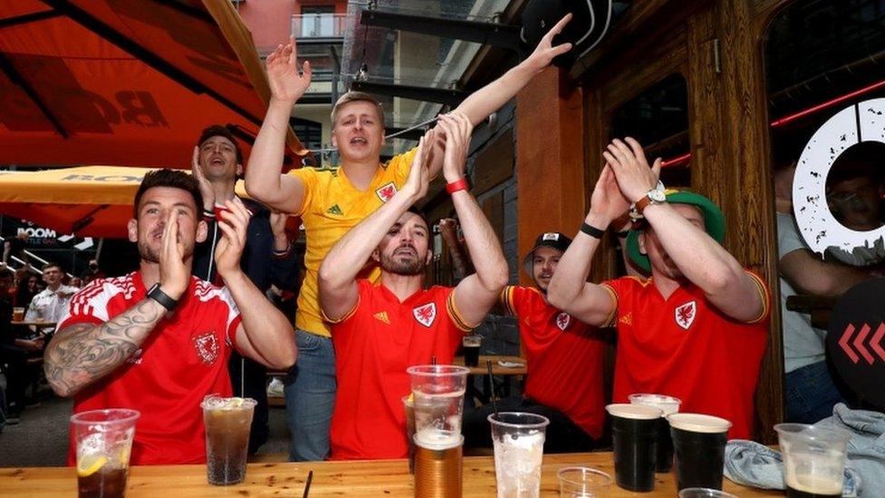 Wales fans react as they watch the Euro 2020 match between Italy and Wales at Boom: Battle Bar in Cardiff. on 20 June