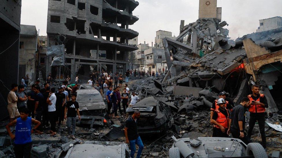 Emergency personnel and Palestinians inspect damages in the aftermath of Israeli strikes, following a Hamas surprise attack, at Beach refugee camp, in Gaza City, October 9, 2023