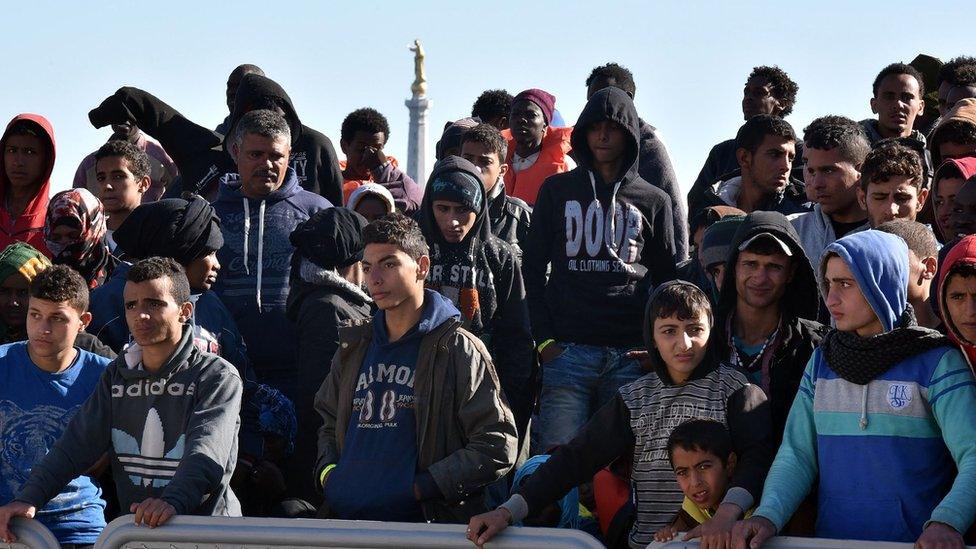 Migrants wait to disembark in Sicily (15 April)