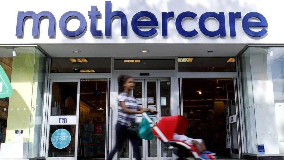 Women with pushchair outside mothercare