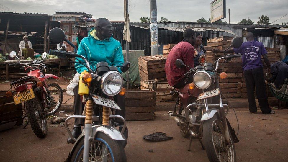 2020/03/28: Boda boda riders in Gulu are seen seated on their motorcycles after they were banned from carrying people