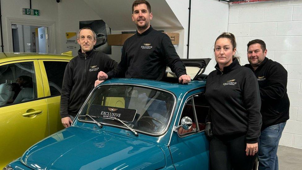 Staff standing by the car