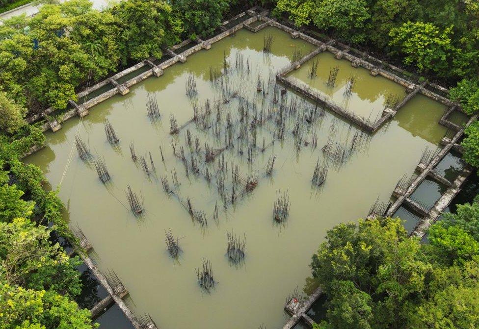 Aerial photograph of uncompleted residential buildings with stagnant water after rainstorm, Beihai, Guangxi, China, on August 2, 2023.