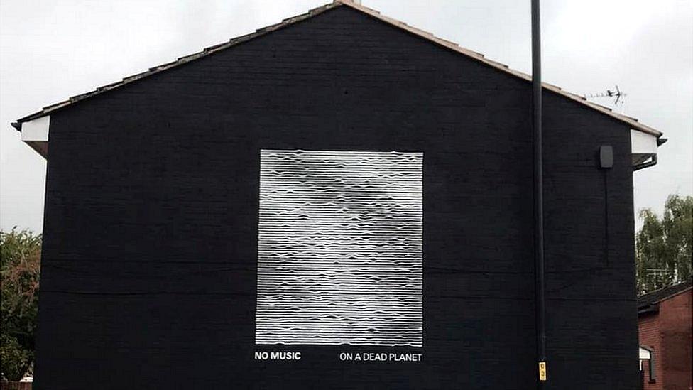 mural with flat lines and no music on a dead planet written below