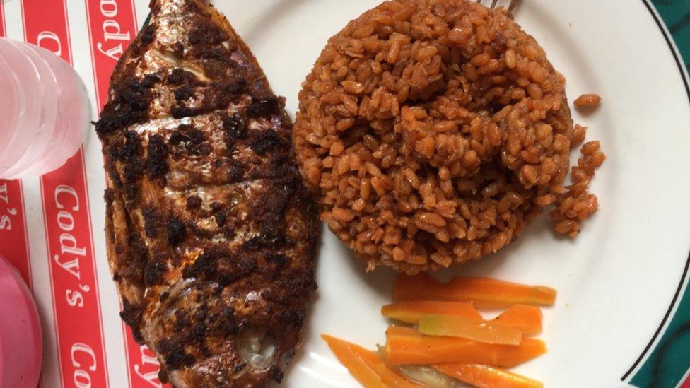 Plate of Jollof rice, carrots and fish